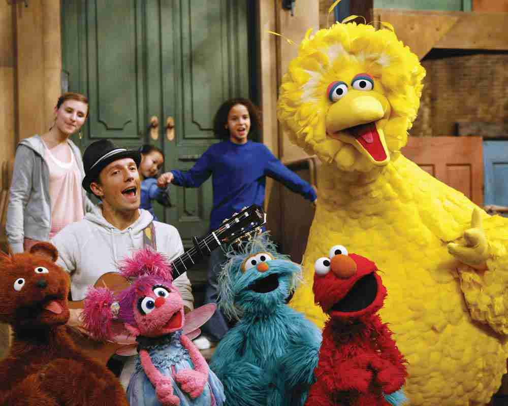 Jason Mraz sits on a stoop and serenades Big Bird, Elmo, and friends on Sesame Street.